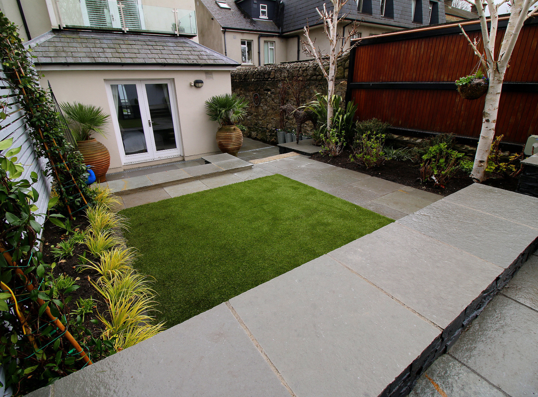 Rathmines garden featuring a terraced layout to lawn and patio spaces | Owen Chubb Garden Landscapers