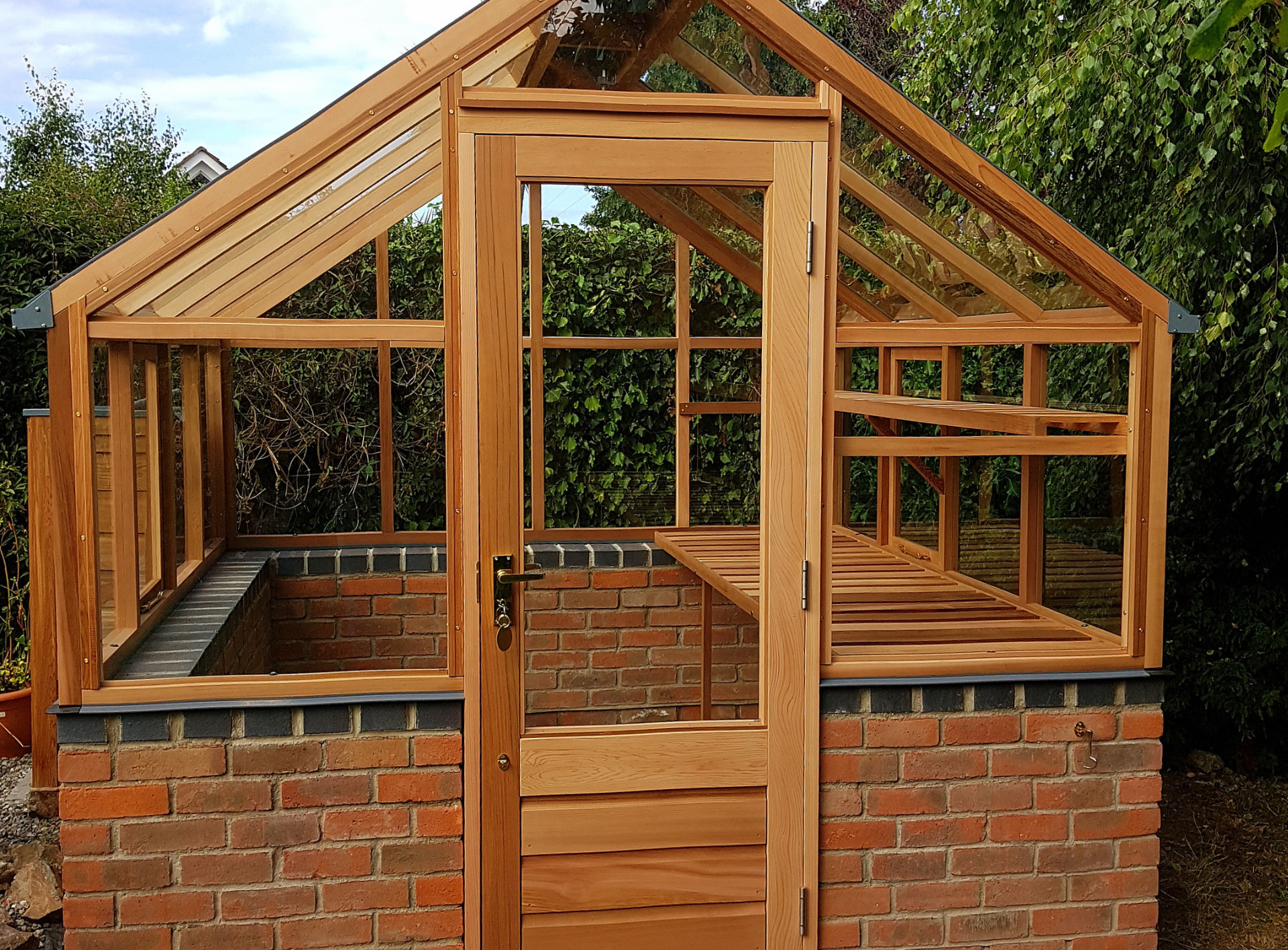 Gabriel Ash Classic Eight (8 x 8) Greenhouse on brick wall and with hinged door entrance in Dublin 18 | the only timber greenhouses endorsed by the RHS | Owen Chubb  087-2306128