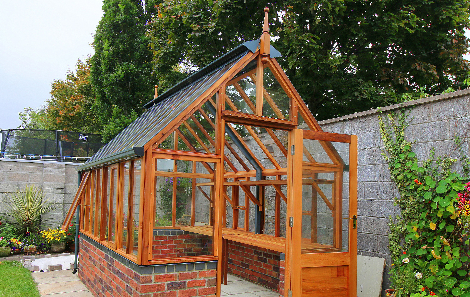 Traditional Victorian Timber Greenhouse - RHS Hyde Hall on dwarf wall