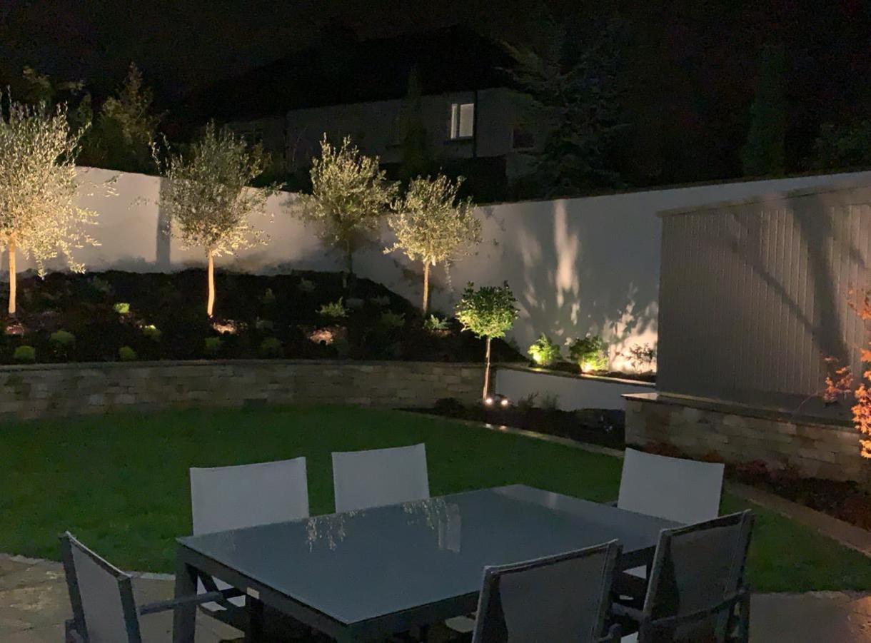 Family patio after dark | Garden Design & Landscaping in Rathfarnham, Dublin 14