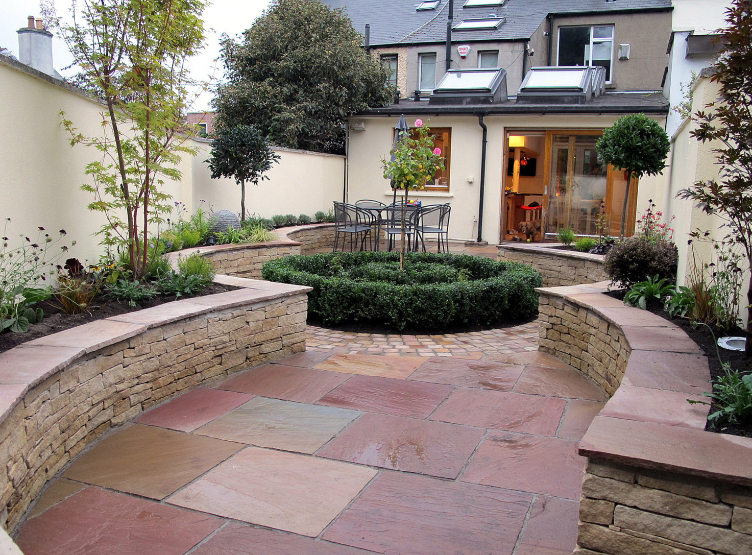 An attractive concentric garden design incorporating central bed, patio and raised beds in Ranelagh garden |Owen Chubb Garden Design & Landscaping in Dublin 6