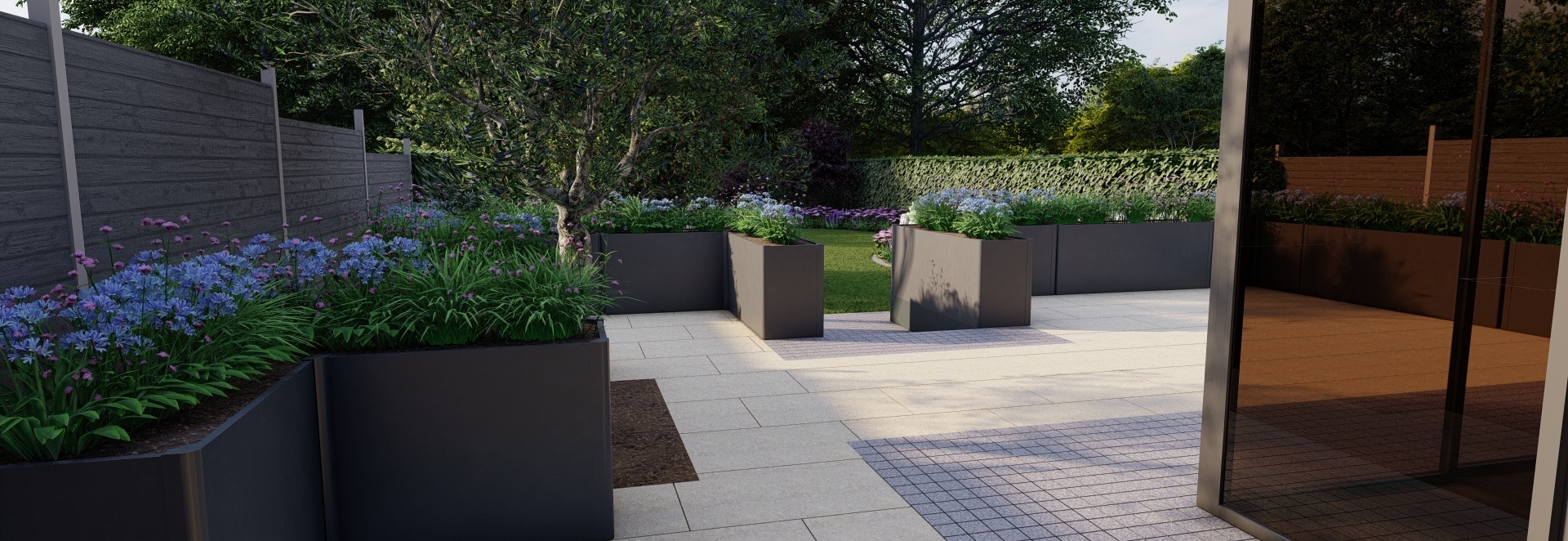 A Garden Design for a large Family garden in Mount Merrion, Co Dublin features an expansive  Raised Patio with the emphasis on the provision of space for separate formal & casual dining areas framed by stunning Biohort Steel Planters, Egyptian Limestone paving, colourful low maintenance Herbaceous planted borders and large lawn area |   Owen Chubb Garden Design, Tel 087-2306 128