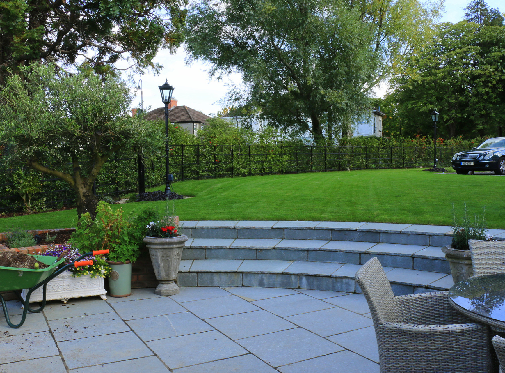 Sunken patio in limestone finish with concentric steps | Owen Chubb Garden Landscapers