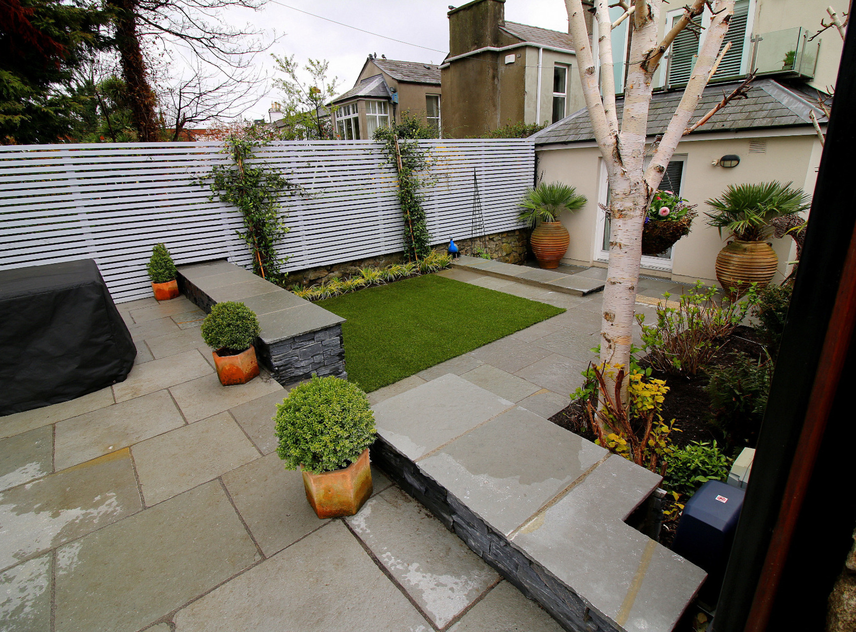Split-level garden patios in Rathmines garden with bespoke garden fencing | Owen Chubb Garden Design