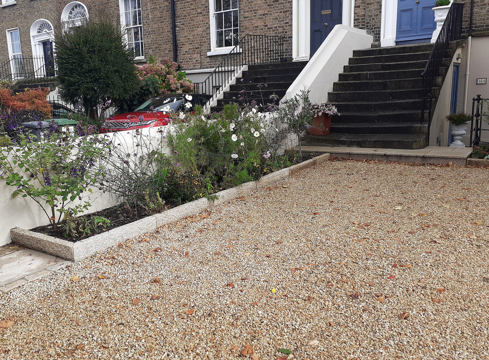 Driveway installation in Rathgar, Dublin 6 featuring entrance in yellow granite setts, borders edged with yellow granite kerbing & surface finished ballylusk stone chippings  | Owen Chubb Garden Design & Landscaping, Tel 087-2306128