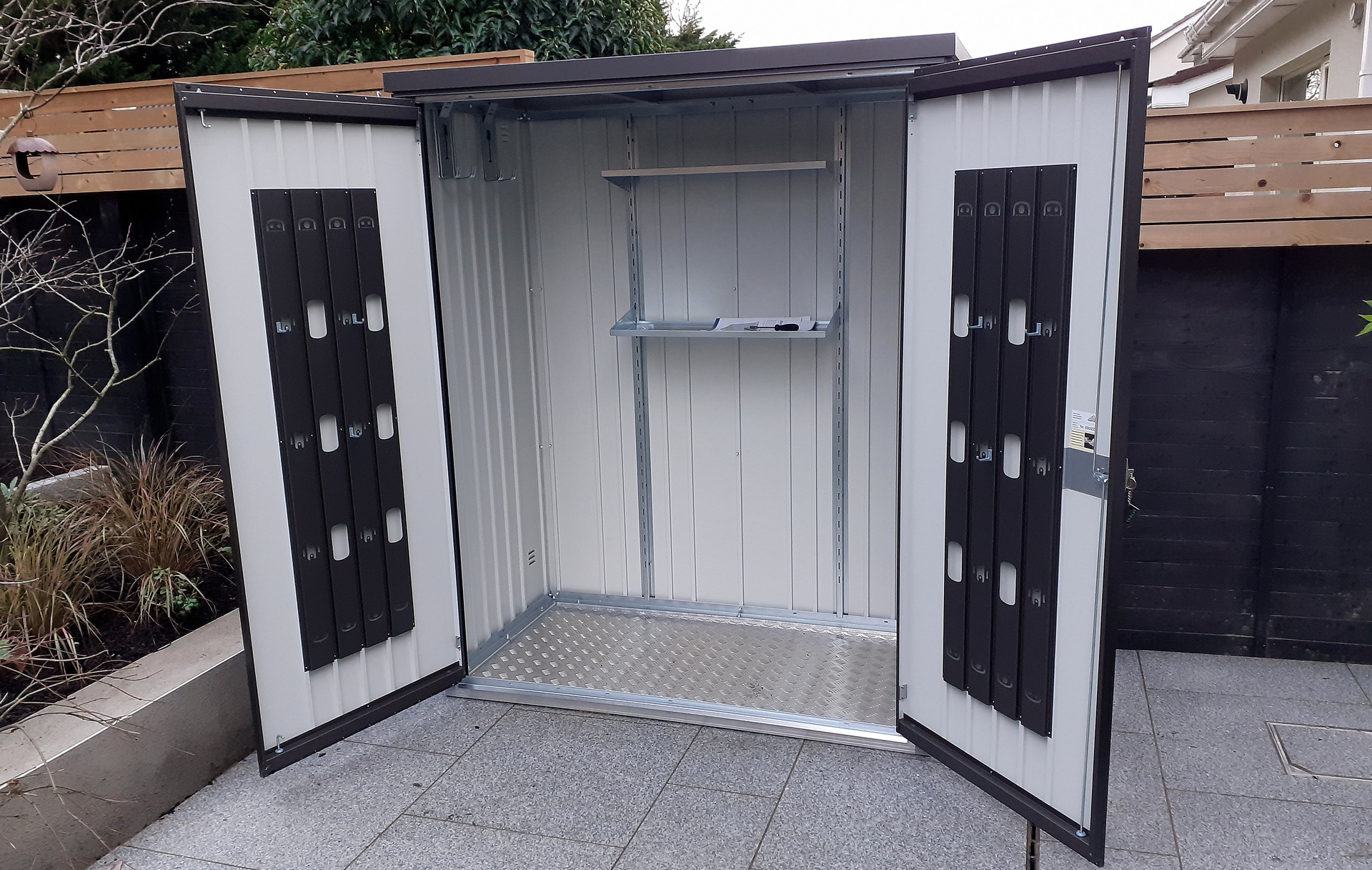 The superb quality and style of the Biohort Equipment Locker 150 in metallic dark grey  with optional accessories including aluminium floor frame, aluminium floor panels | supplied + installed in Castleknock by Owen Chubb Landscapers. Tel 087-2306 128.
