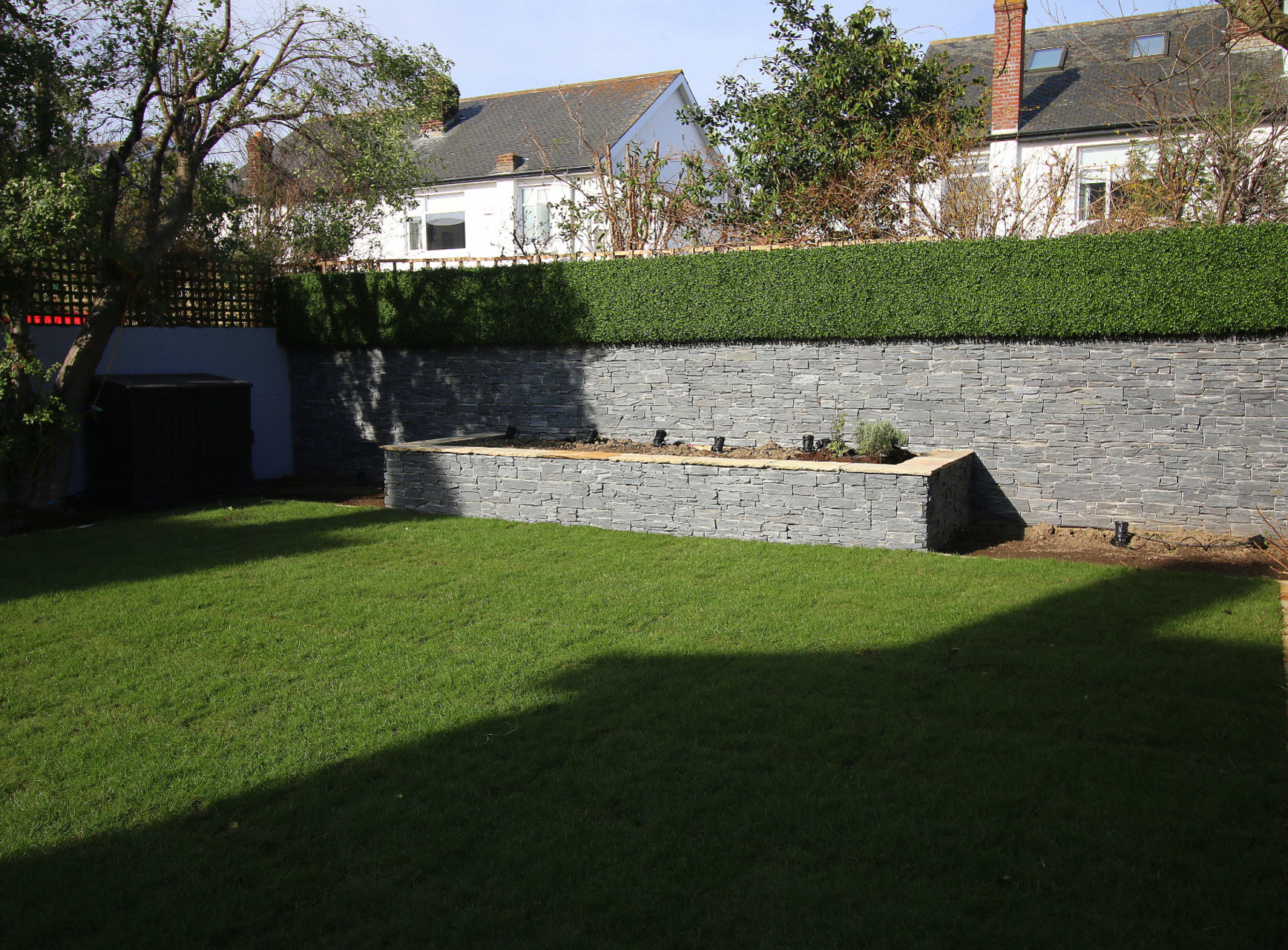 Stone Cladding combined with synthetic Boxwood Cladding creates a hardwearing zero maintenance Feature garden wall | Terenure, Dublin 6W