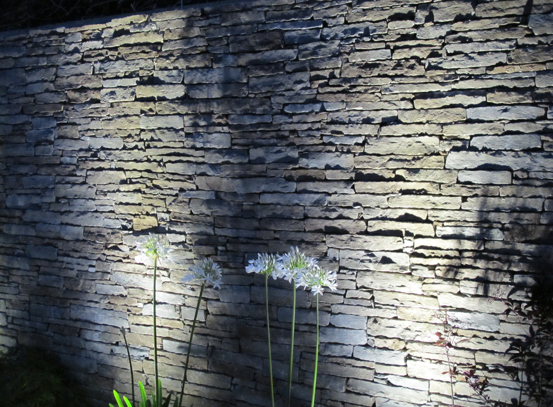 Natural stone a stunning garden wall finish for garden walls and an eye catching visual feature after dark