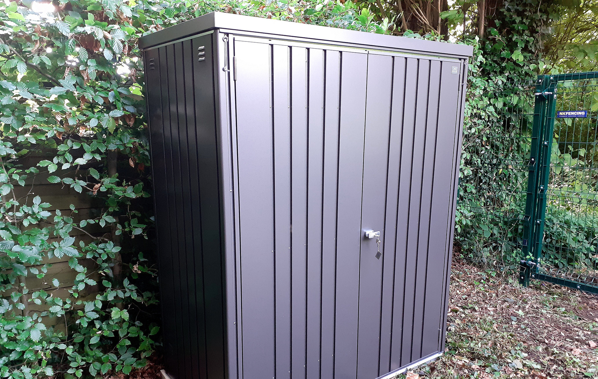 The superb quality and style of the Biohort Equipment Locker 150 in metallic dark grey  with optional accessories including aluminium floor frame, aluminium floor panels | supplied + installed in Belfast by Owen Chubb Landscapers. Tel 087-2306 128.